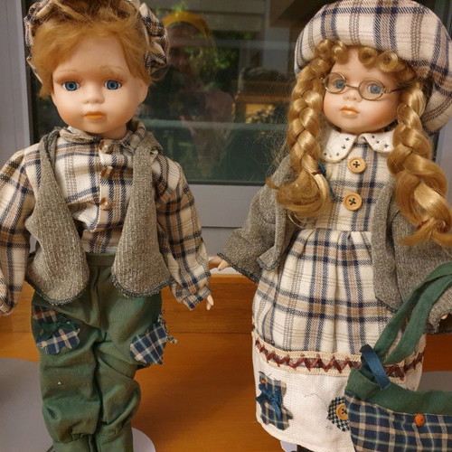 Porcelain dolls new with handmade clothes and support base