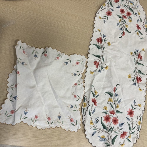 White embroidered table runner and napkin set used with colorful flowers