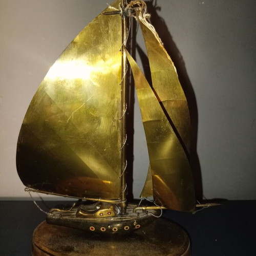 Vintage brass sailboat sculpture on wooden base, used