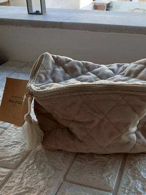 Toiletry bag new, beige synthetic velvet fabric