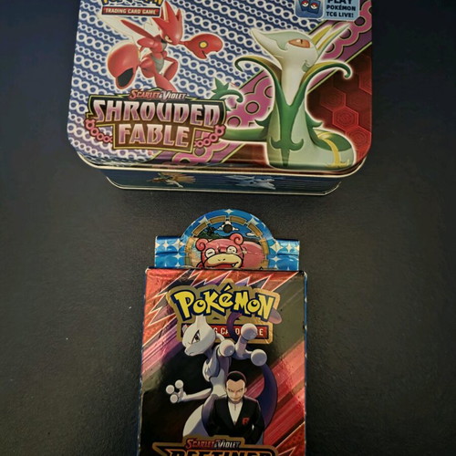 Pokemon cards like new, non-authentic with metal tin and extra cards