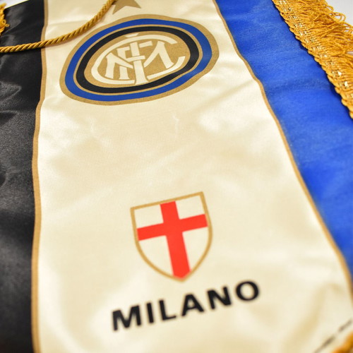 Inter collection with scarves, pennants, cufflinks, magazines and backpack