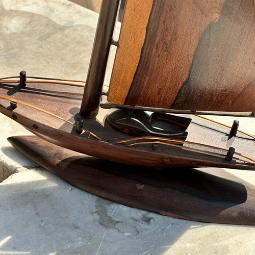 Handmade wooden sailboat used on base, modern nautical decoration