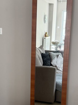 Full-Length Wall Mirror with Wooden Frame and Metal Details used