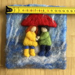 Handmade wool wall art with children under umbrella