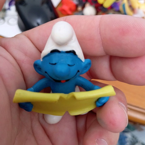 Smurf figure used reading a book
