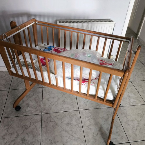 Wooden baby cot like new with wheels and mosquito net