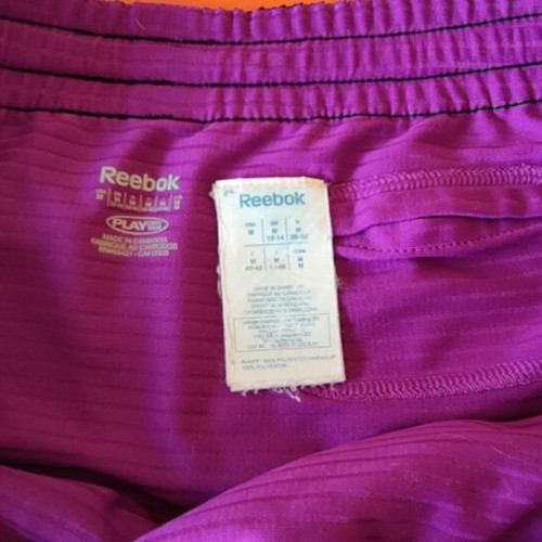 Reebok women's PlayDry ZigTech running shorts used, black and purple, size M