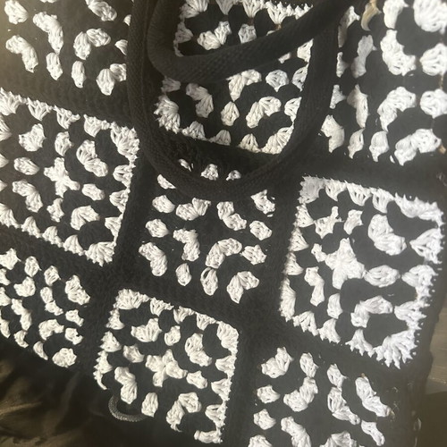 Handmade jute bag with black and white crochet motifs