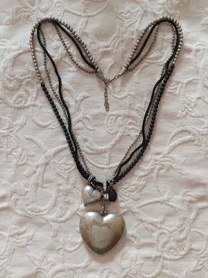 Vintage Gil Holsters necklace like new with black cords and silver hearts