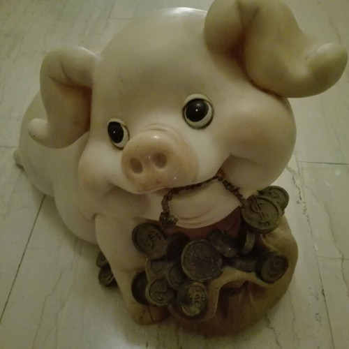 Piggy bank vintage used with gold coins