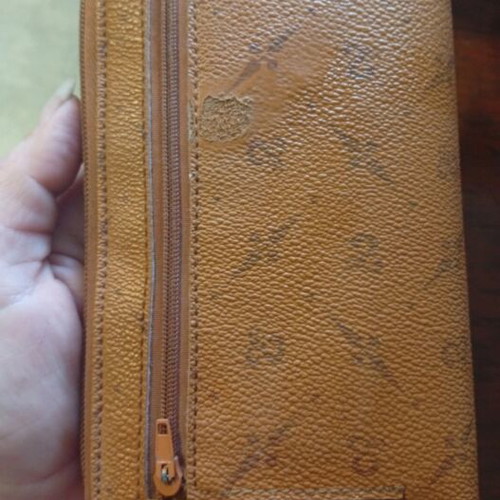Wallet used camel color with many pockets and minor defect