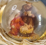 Christmas decorative snow globe featuring the Nativity and a base shaped like an angel's wing