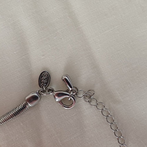 Geometric necklace used with blue and purple designs, Marks & Spencer