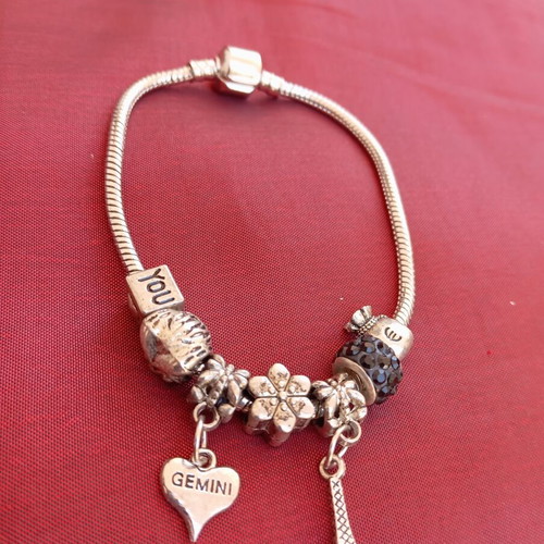 Steel bracelet with removable charms like new