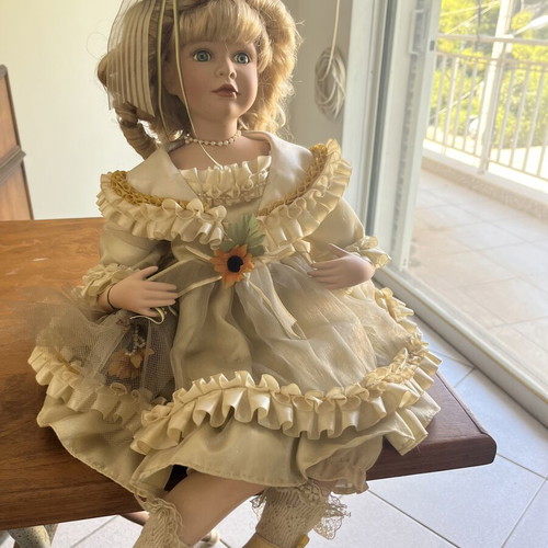 Porcelain doll sitting with curls, vintage