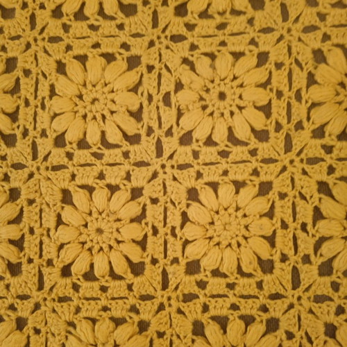 Knitted handmade blanket used with embossed daisies