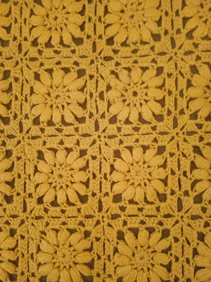 Knitted handmade blanket used with embossed daisies
