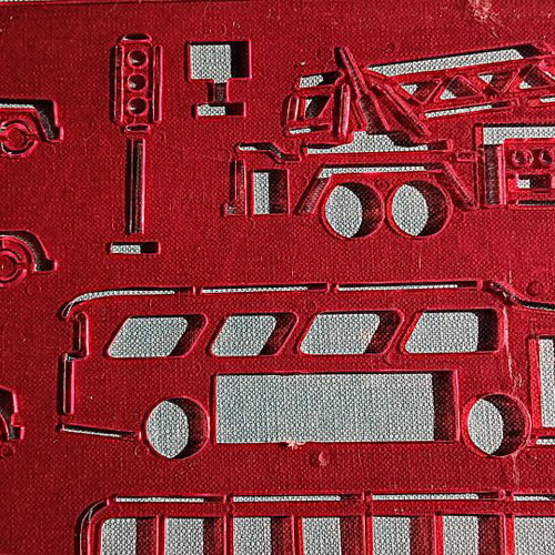 Red plastic stencil with vehicle designs
