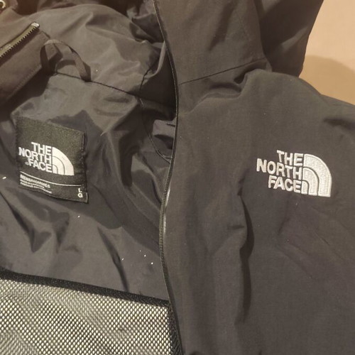 The North Face waterproof windbreaker jacket used, size large, black