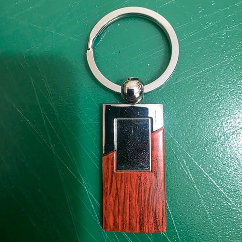 Set of three gifts in luxury wooden box with pen, lighter and keychain