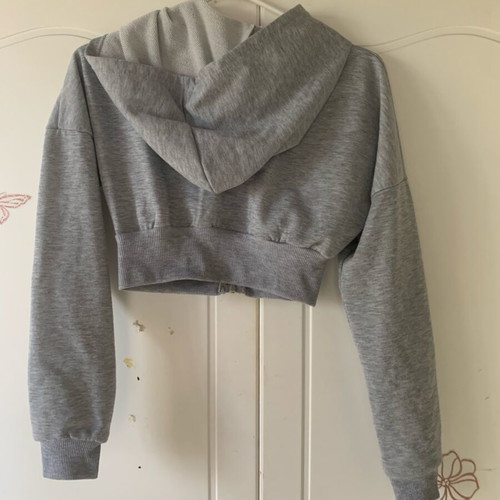 Cropped zip up hoodie used, grey with green lettering, size XS