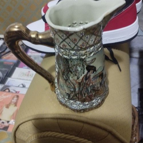 Collectible ceramic pitcher with embossed decorations, new