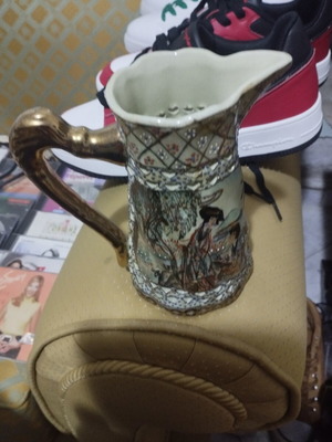 Collectible ceramic pitcher with embossed decorations, new