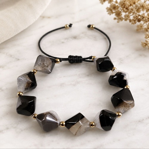 Handmade bracelet with natural black and gray stones and gold details