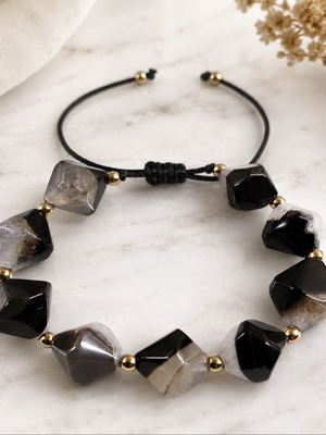Handmade bracelet with natural black and gray stones and gold details