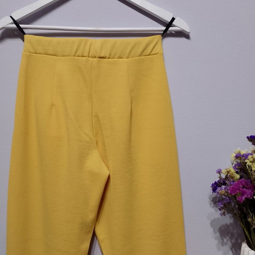 Yellow fabric pants used with elastic waist and pockets