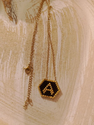 Stainless steel necklace new with Miyoki monogram black and gold