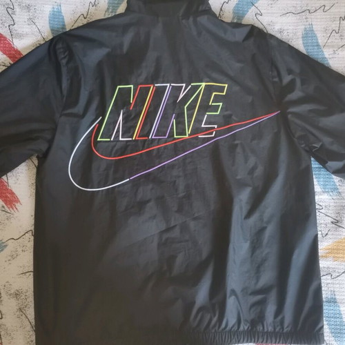 Nike unisex jacket used with colorful letters and small tear