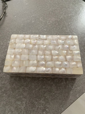Box with glossy beige-white texture