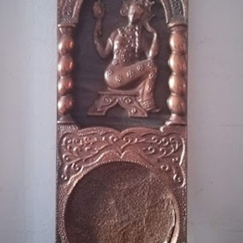 Decorative fireplace set with table and copper wall plaque