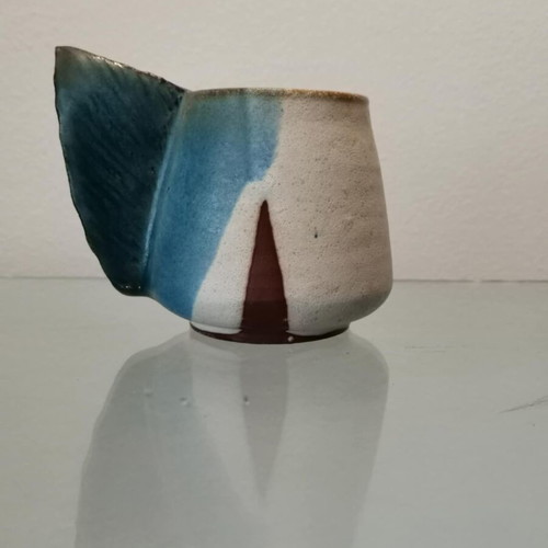 Clay handmade mug used with wavy handle