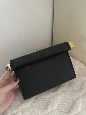 Minimal black handbag with unique closure like new
