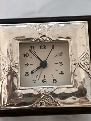 Silver table clock used with wooden frame