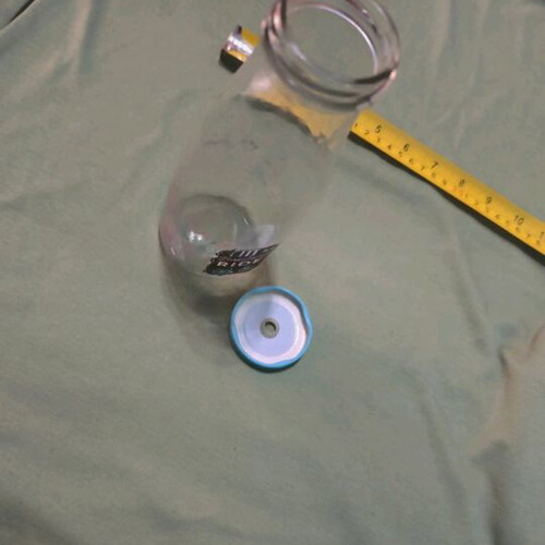 Glass water bottle used with hole for straw