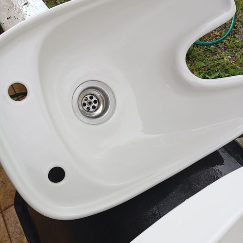 White porcelain hair salon sink used
