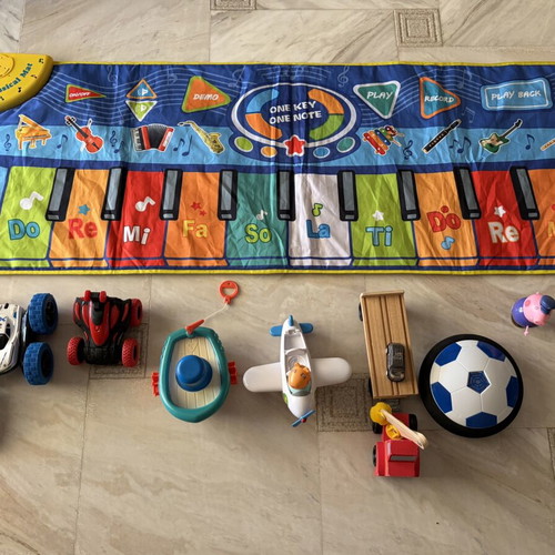 Toy set used with musical mat piano, remote car, boat, airplane, truck, football, figurine