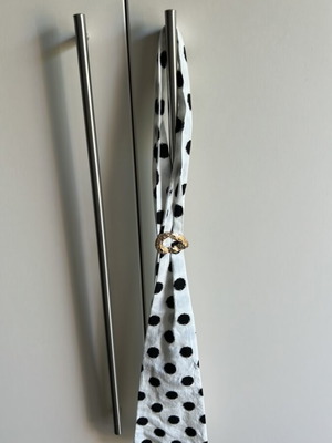 Black and white polka dot neck scarf with gold brooch