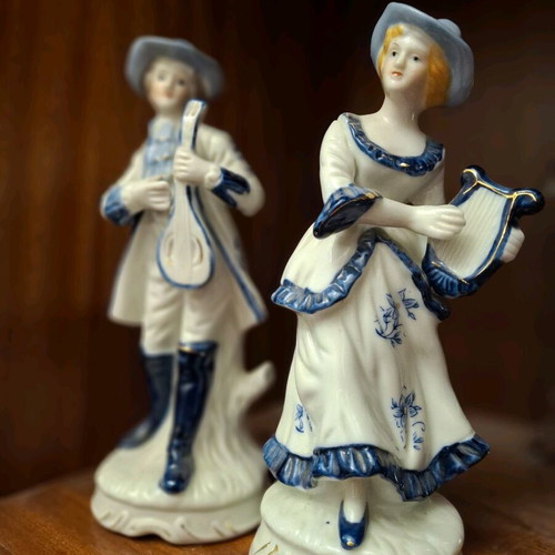 Porcelain figurine set used, woman with lyre and man with mandolin