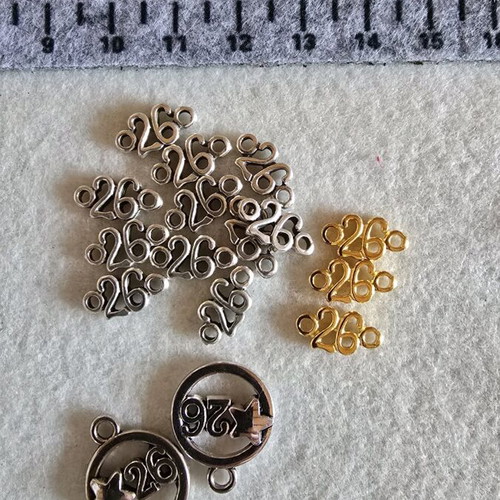Metal motifs like new with number 26 in gold and silver color