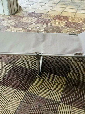 Folding beach lounger with metal frame and adjustable backrest