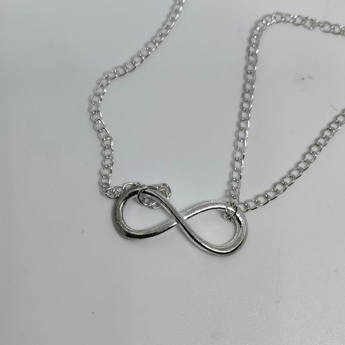 Silver necklace with infinity and cross symbols like new
