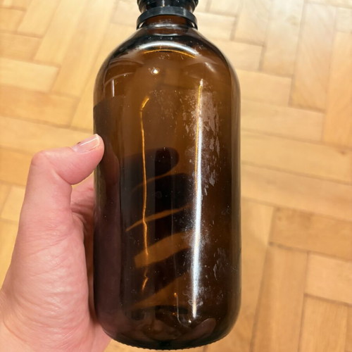 Brown glass pharmacy-style bottle with cap