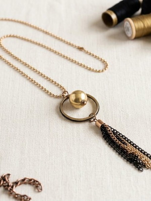Long statement necklace like new, black and gold tassel pendant