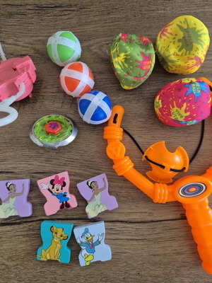 Various toys like new, including slingshot, spinning top, Disney wooden figures