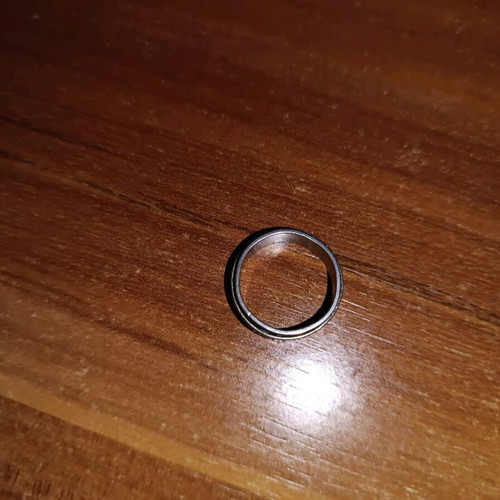 Steel ring used, silver with wear on design color